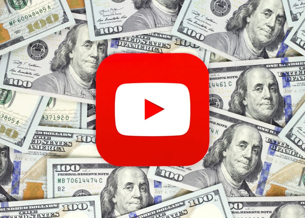 How to Make Money on YouTube: A YouTube play button over a stack of US $100 bills. Ben Franklin looks bemused. 
