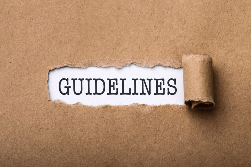 Decorative image for YouTube Community Guidelines. A brown paper fills the frame. It has been ripped in the center to reveal the word "GUIDELINES" below. 